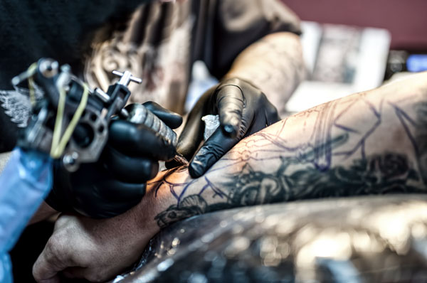 tattoo artist in action