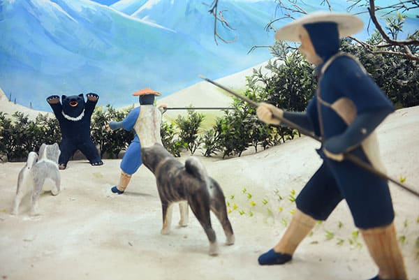 Japanese reenactment with figurines and Japanese dog